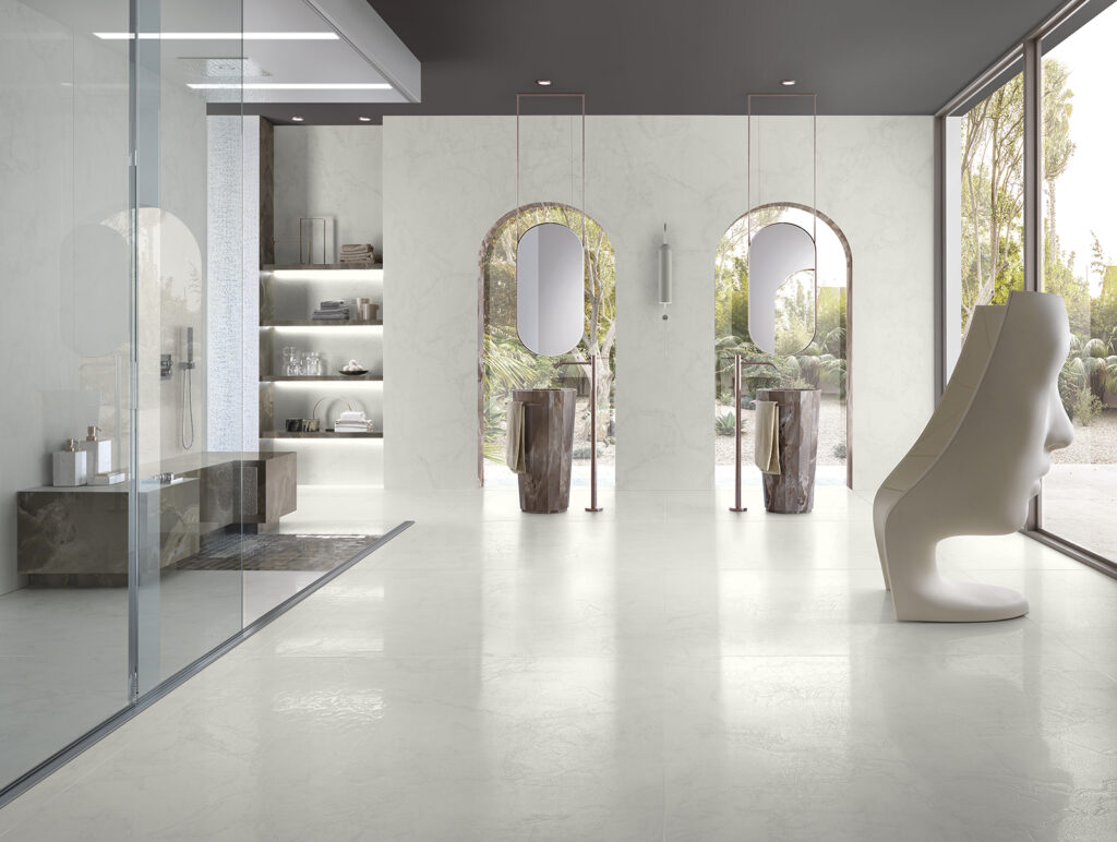 Bathroom featuring a shower and double vanity, all clad in marble-effect porcelain stoneware