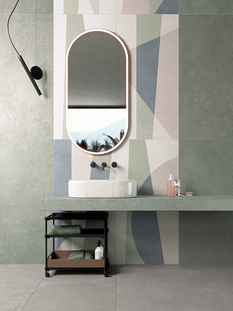 bagno rivestito in gres effetto cemento verde e una parte con forme geometriche